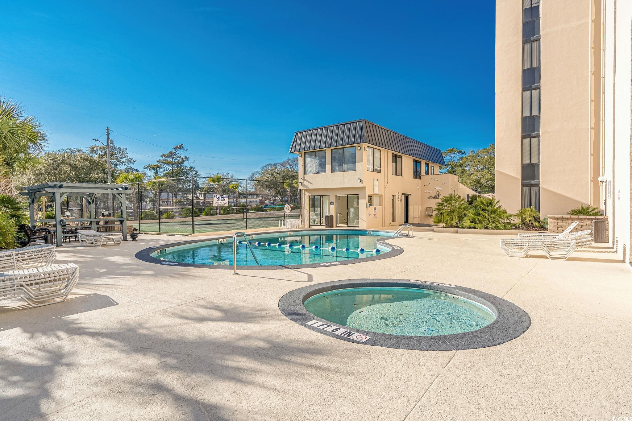 601 Mitchell Drive, Unit 207 Myrtle Beach, SC 29577 - Photo 27 of 38 Community pool with a community hot tub, a patio area, and a pergola