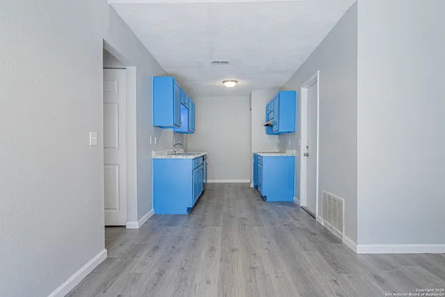 a view of kitchen and wooden floor