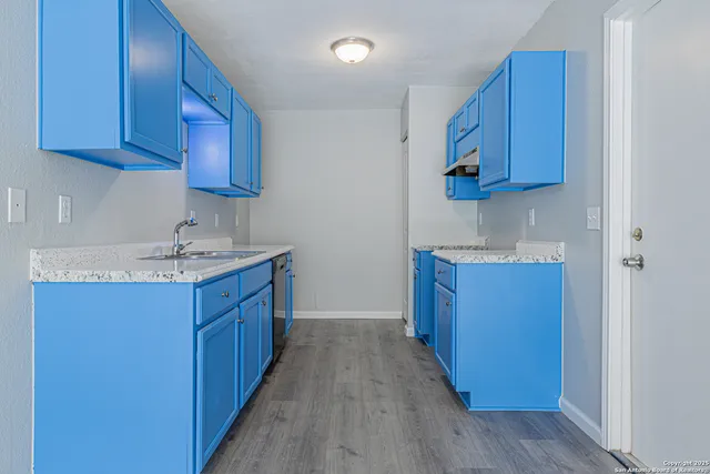 a kitchen with stainless steel appliances granite countertop wooden cabinets a sink and dishwasher