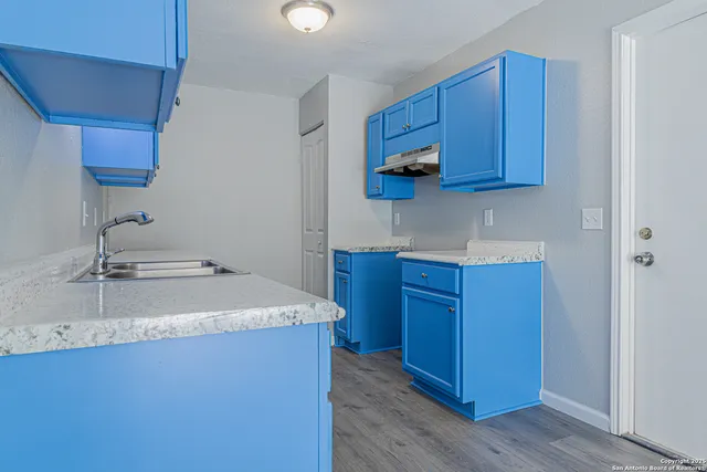 a kitchen with wooden cabinets and sink