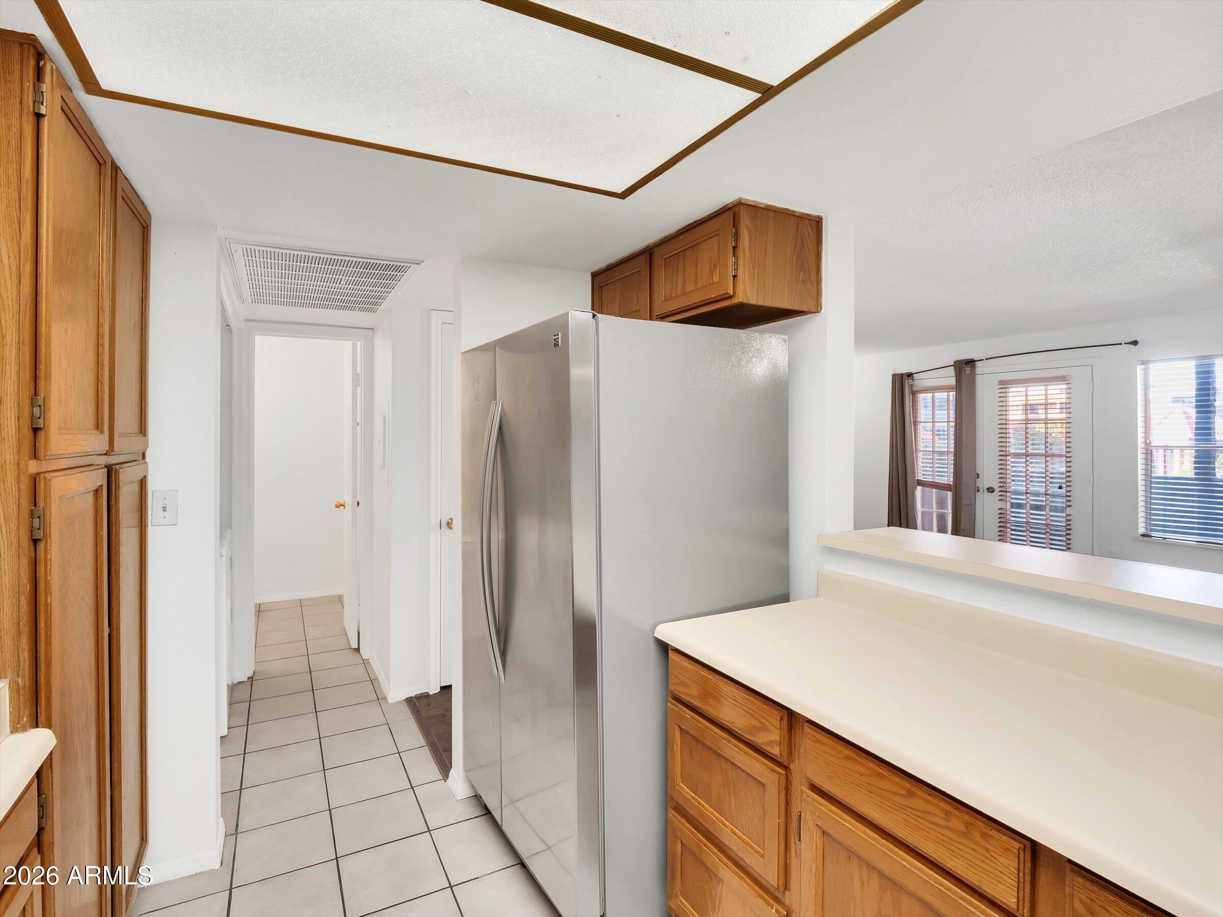 1645 West Baseline Road, Unit 2072 Mesa, AZ 85202 - Photo 13 of 37 a kitchen with a refrigerator and a sink