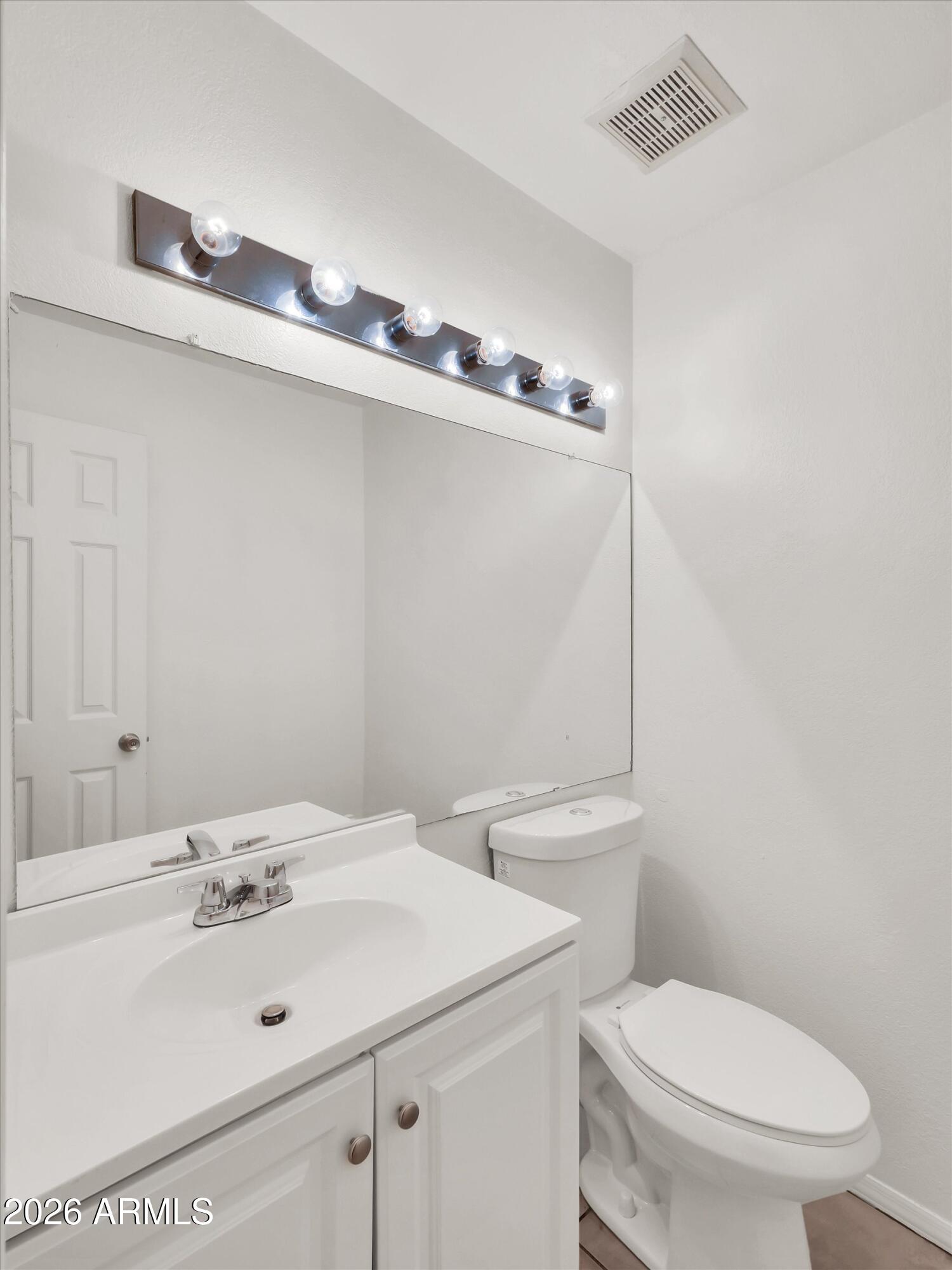 1645 West Baseline Road, Unit 2072 Mesa, AZ 85202 - Photo 17 of 37 a bathroom with a sink a toilet and a mirror