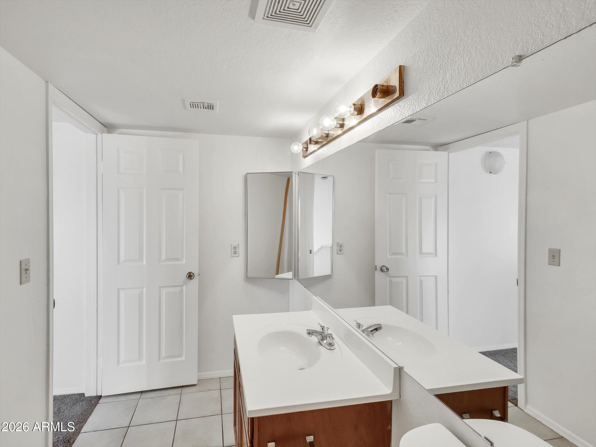 1645 West Baseline Road, Unit 2072 Mesa, AZ 85202 - Photo 25 of 37 a utility room with cabinets washer and dryer
