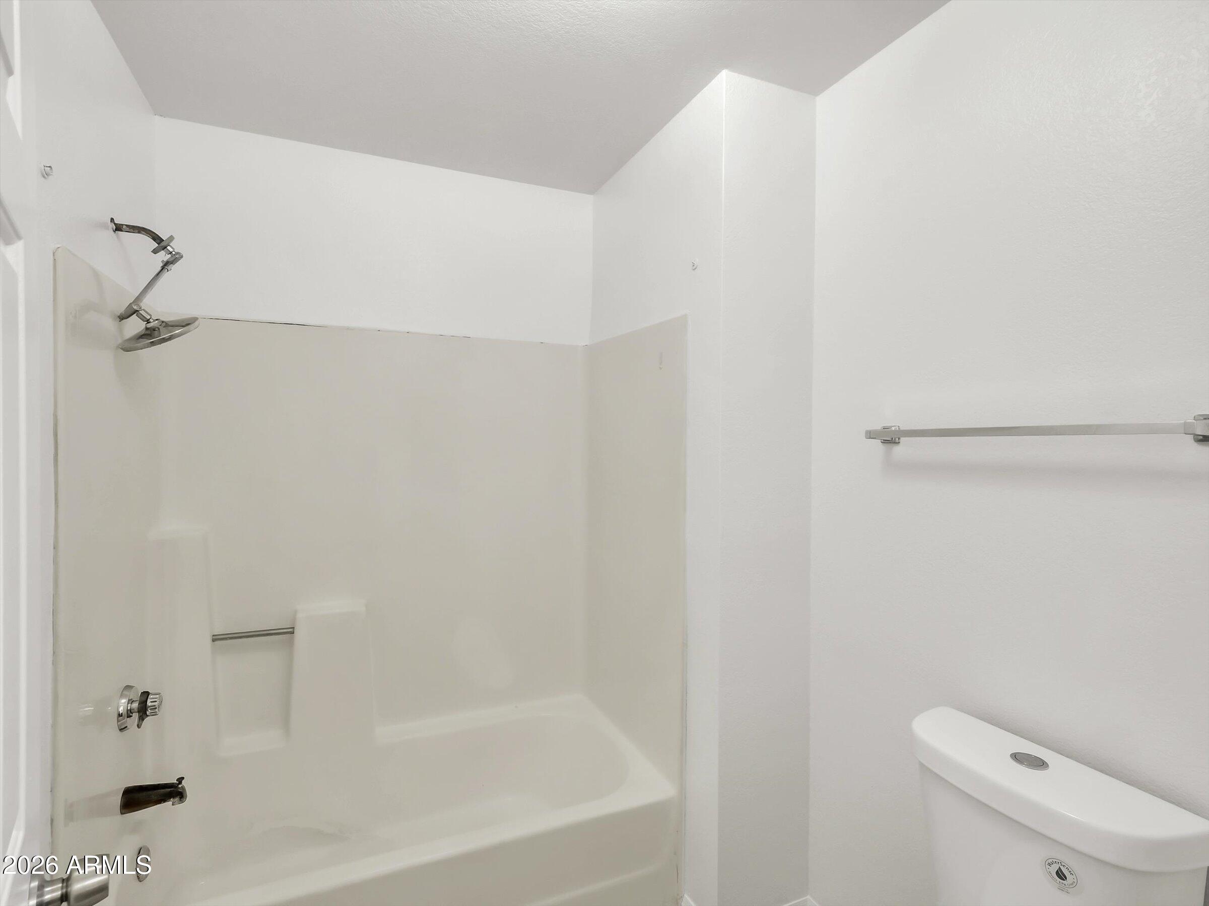 1645 West Baseline Road, Unit 2072 Mesa, AZ 85202 - Photo 31 of 37 a bathroom with a shower and toilet