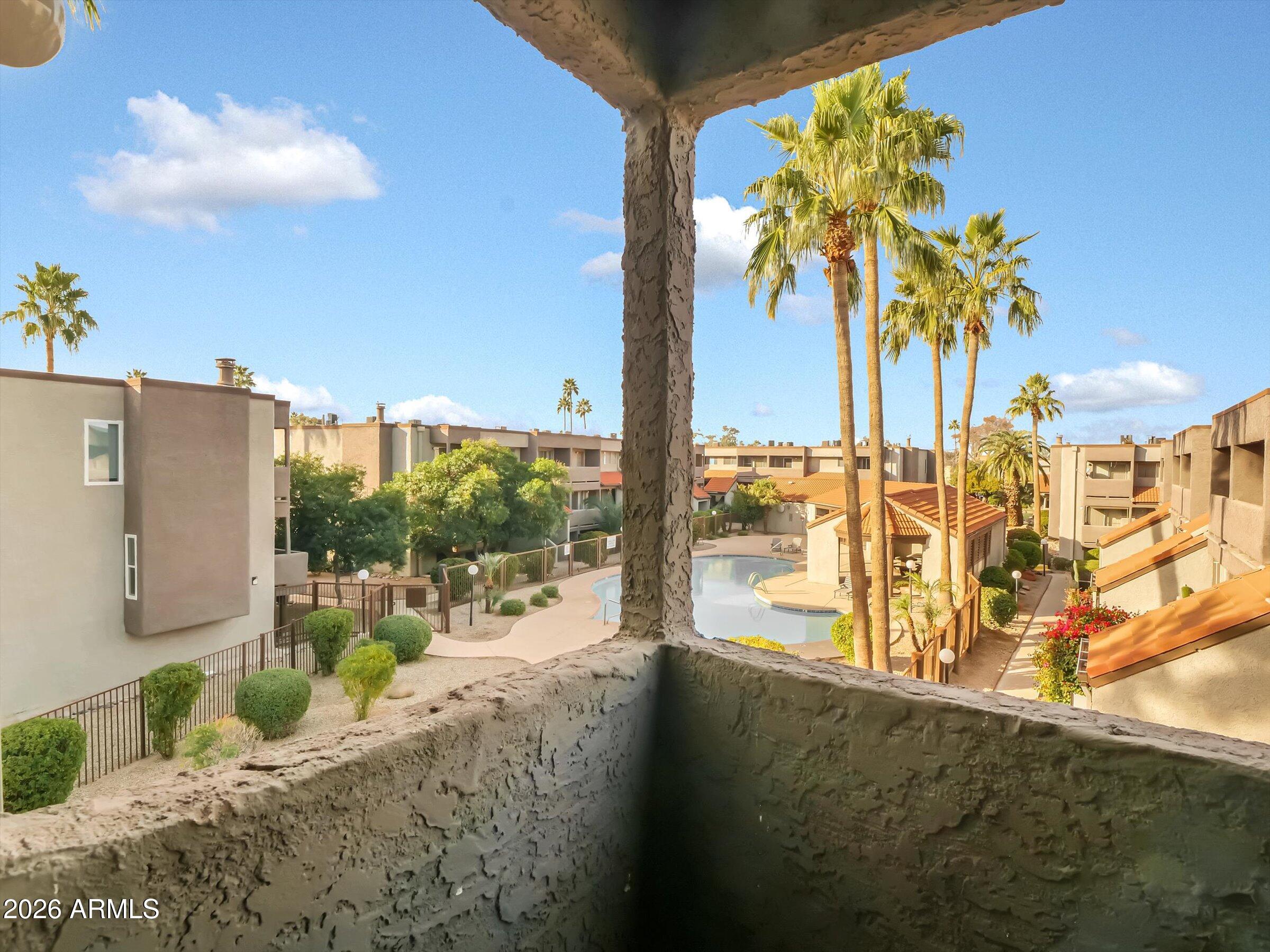 1645 West Baseline Road, Unit 2072 Mesa, AZ 85202 - Photo 33 of 37 a view of a balcony with floor to ceiling windows and wooden floor