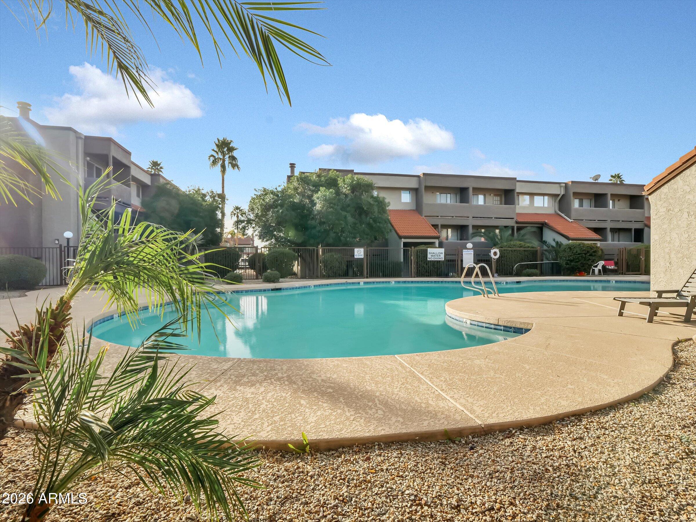 1645 West Baseline Road, Unit 2072 Mesa, AZ 85202 - Photo 37 of 37 a view of a swimming pool with a yard