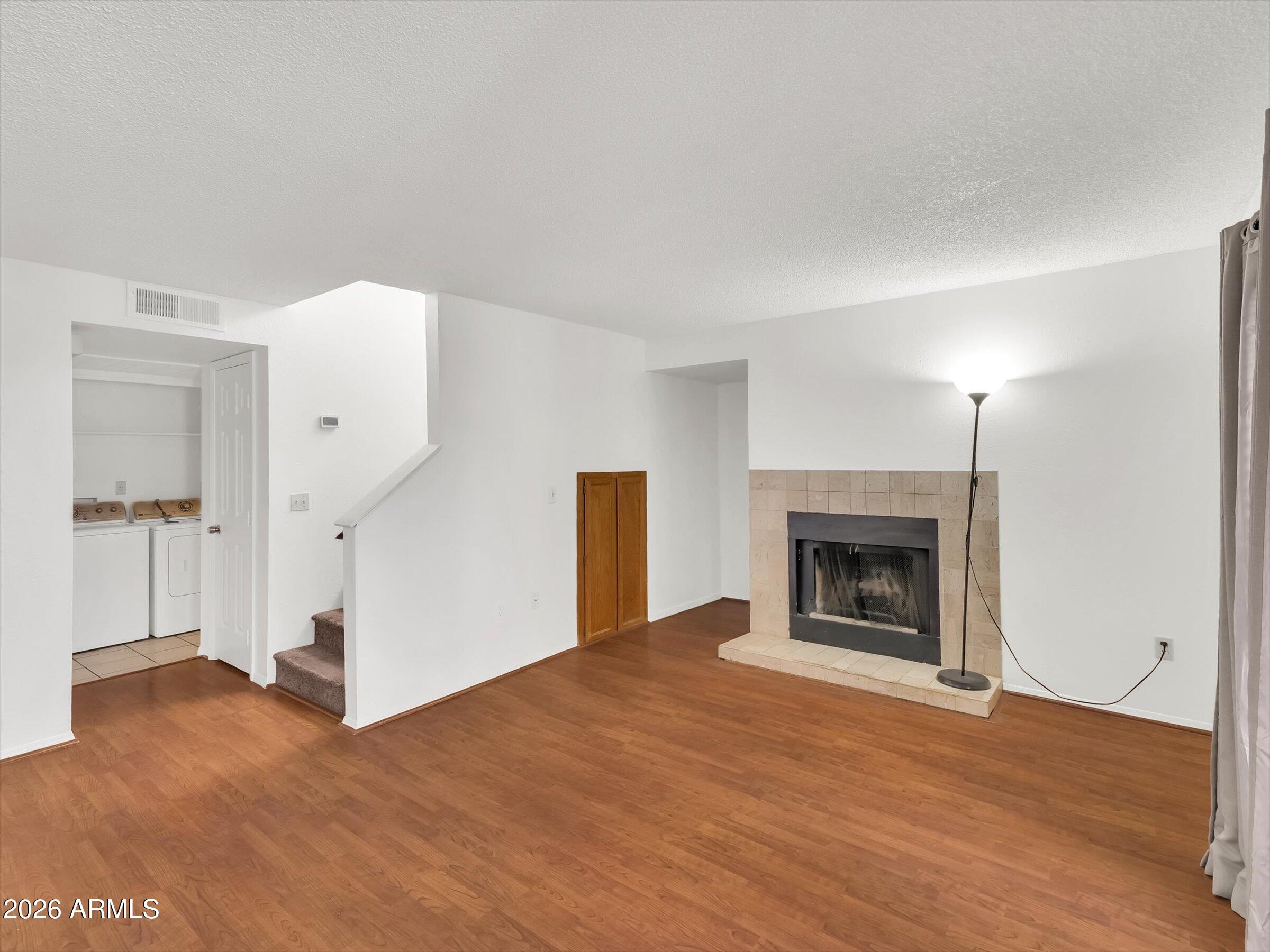 1645 West Baseline Road, Unit 2072 Mesa, AZ 85202 - Photo 5 of 37 a view of empty room with a fireplace and wooden floor