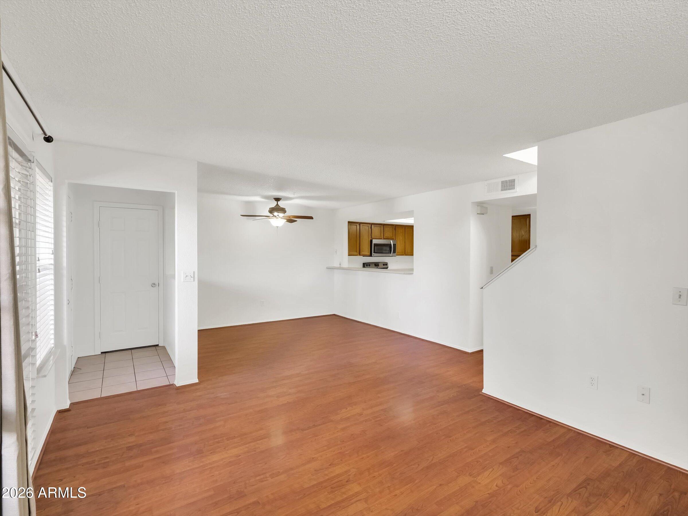 1645 West Baseline Road, Unit 2072 Mesa, AZ 85202 - Photo 6 of 37 a view of empty room with wooden floor