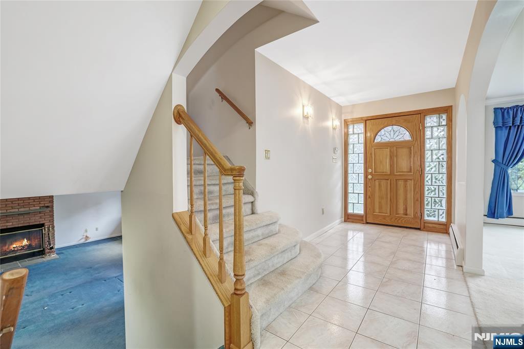 31 Collins Avenue Closter, NJ 07624 - Photo 11 of 37 a view of a livingroom with wooden floor and stairs