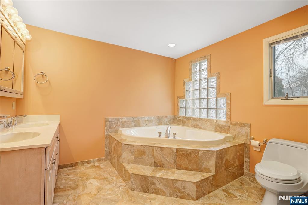 31 Collins Avenue Closter, NJ 07624 - Photo 19 of 37 a spacious bathroom with a bathtub and sink