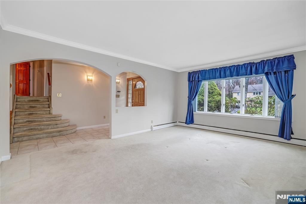 31 Collins Avenue Closter, NJ 07624 - Photo 2 of 37 a view of an empty room with a fireplace and a window