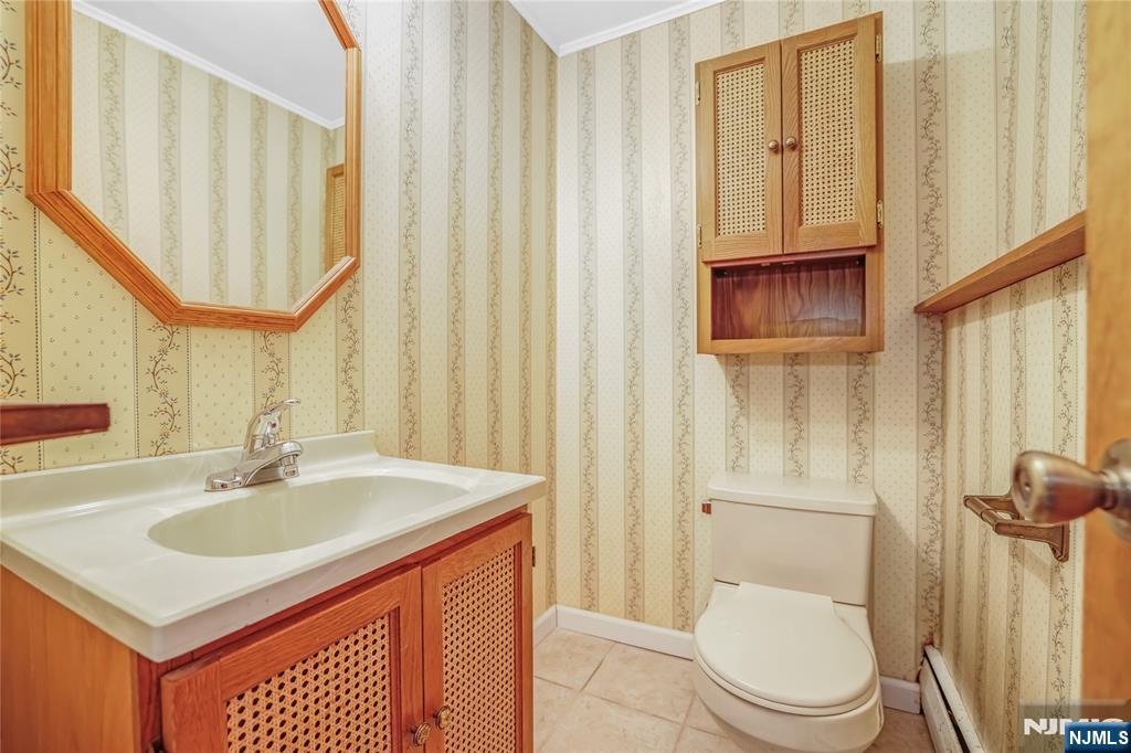 31 Collins Avenue Closter, NJ 07624 - Photo 26 of 37 a bathroom with a sink a toilet and a mirror
