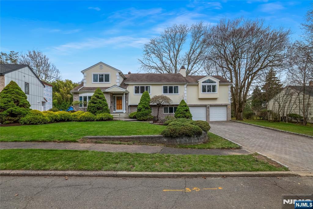 31 Collins Avenue Closter, NJ 07624 - Photo 28 of 37 a front view of a house with a garden