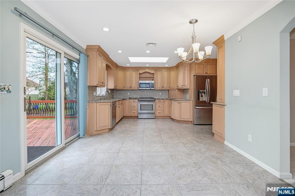 31 Collins Avenue Closter, NJ 07624 - Photo 7 of 37 a large kitchen with lots of counter space and stainless steel appliances