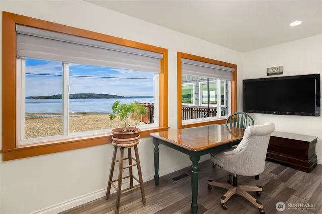 a view of a livingroom with furniture and a flat screen tv