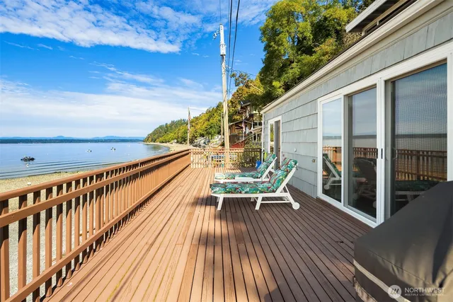 a view of balcony with chairs and wooden fence