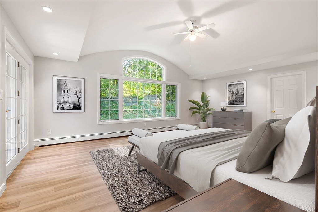 21 Savoy Road Framingham, MA 01701 - Photo 21 of 37 a bedroom with a large bed and a chandelier