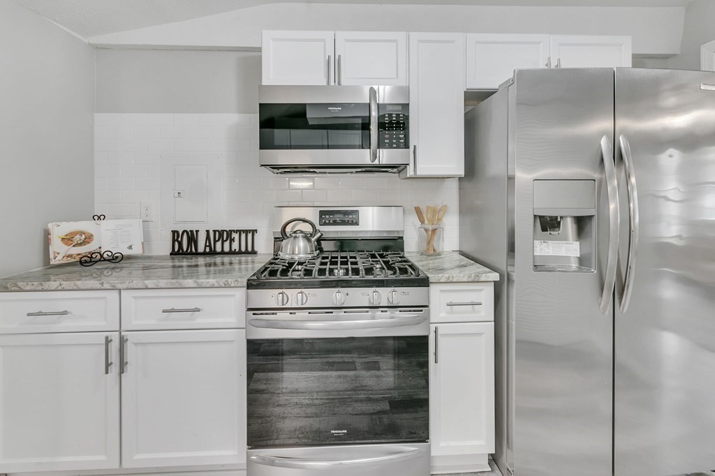 284 Ambrose Street Springfield, MA 01109 - Photo 11 of 29 a kitchen with stainless steel appliances granite countertop a stove a refrigerator and a microwave