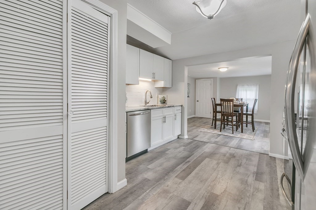 284 Ambrose Street Springfield, MA 01109 - Photo 13 of 29 a kitchen with white cabinets and dining table chair