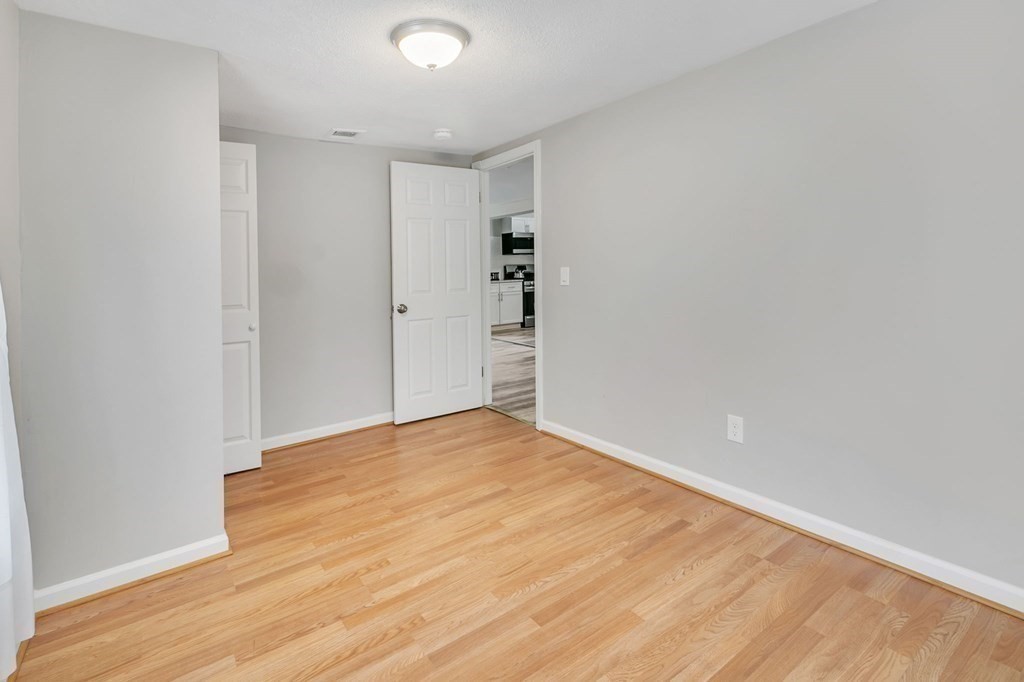 284 Ambrose Street Springfield, MA 01109 - Photo 18 of 29 a view of an empty room with wooden floor