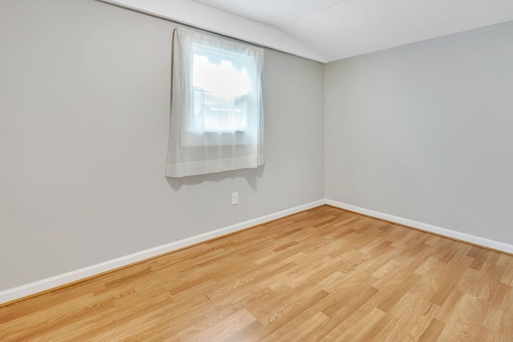 284 Ambrose Street Springfield, MA 01109 - Photo 20 of 29 an empty room with wooden floor and windows