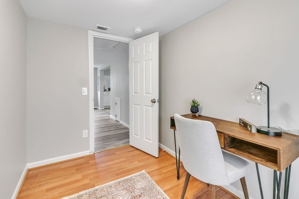 284 Ambrose Street Springfield, MA 01109 - Photo 24 of 29 a view of a room with wooden floor and a potted plant