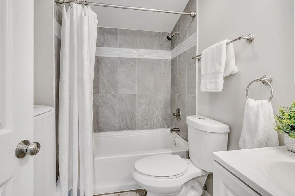 284 Ambrose Street Springfield, MA 01109 - Photo 26 of 29 a white toilet sitting next to a bath tub