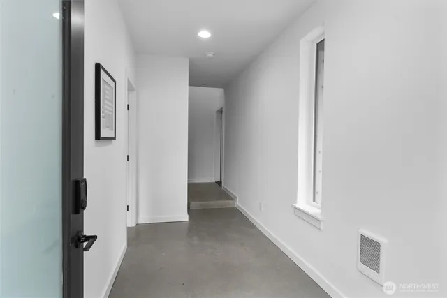 an empty room with windows and closet