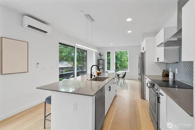 a kitchen with counter top space a sink and appliances