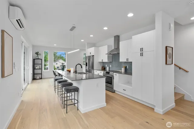 a kitchen with white cabinets and stainless steel appliances