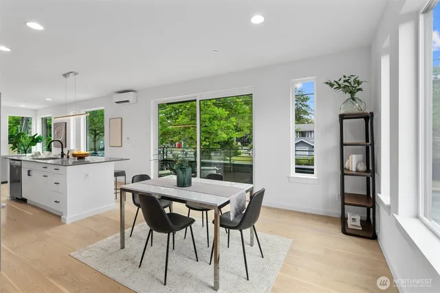 a dining room with a wooden table and chairs