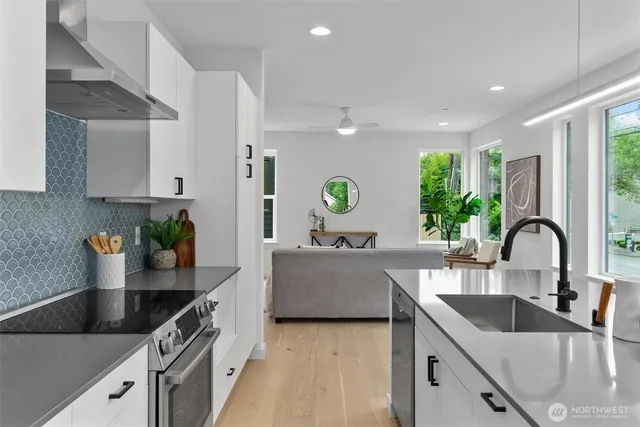 a kitchen with kitchen island granite countertop a sink and wooden cabinets