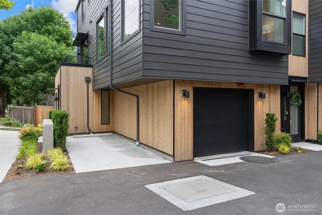 a view of a house with a potted plant and floor to ceiling window and potted plants