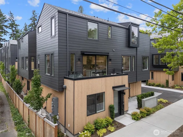 a front view of a house with plants