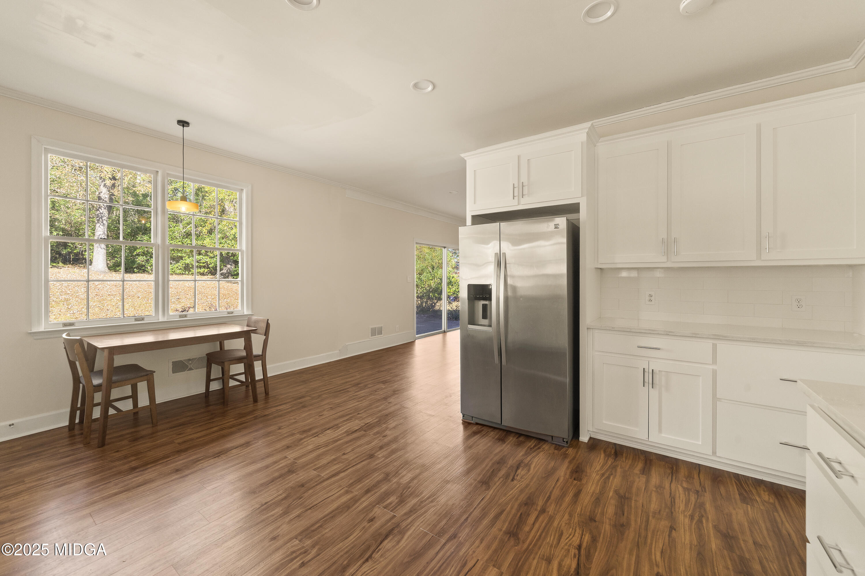 620 Rosa Taylor Drive Macon, GA 31204 - Photo 18 of 45 a kitchen with stainless steel appliances granite countertop a refrigerator a stove a sink dishwasher and a dining table with wooden floor