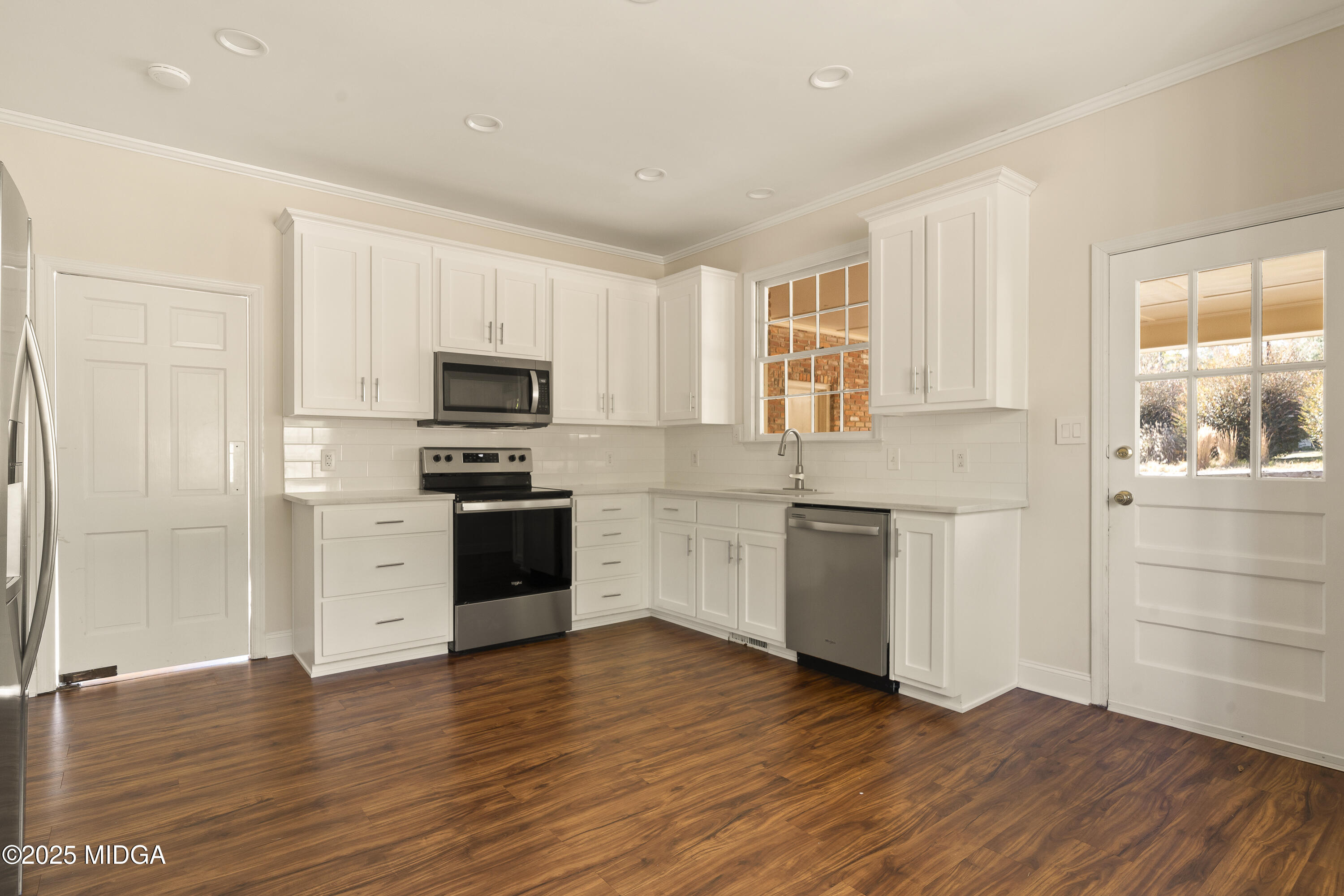 620 Rosa Taylor Drive Macon, GA 31204 - Photo 20 of 45 a kitchen with wooden floors and white appliances