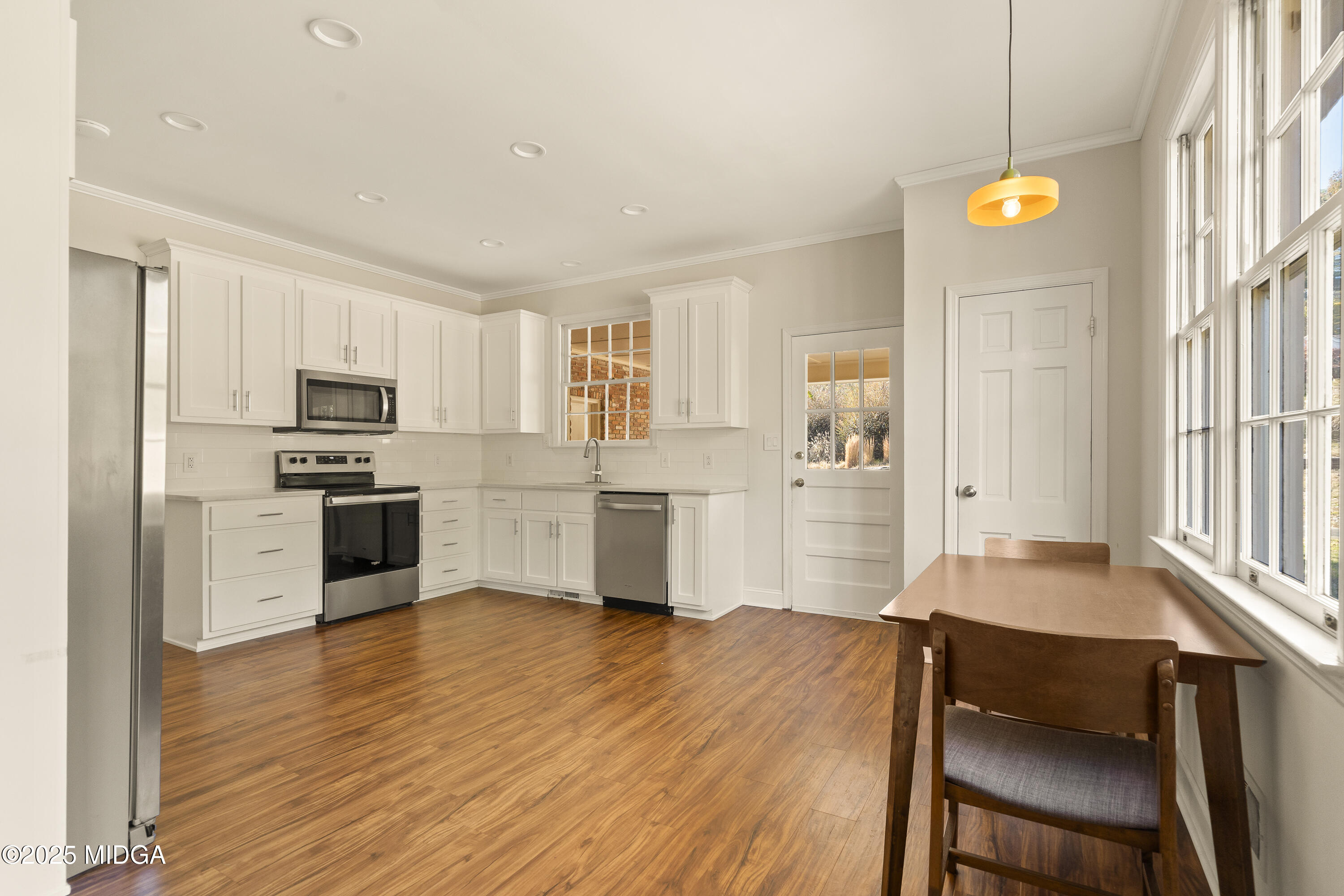 620 Rosa Taylor Drive Macon, GA 31204 - Photo 21 of 45 a kitchen with granite countertop wooden floors and white cabinets