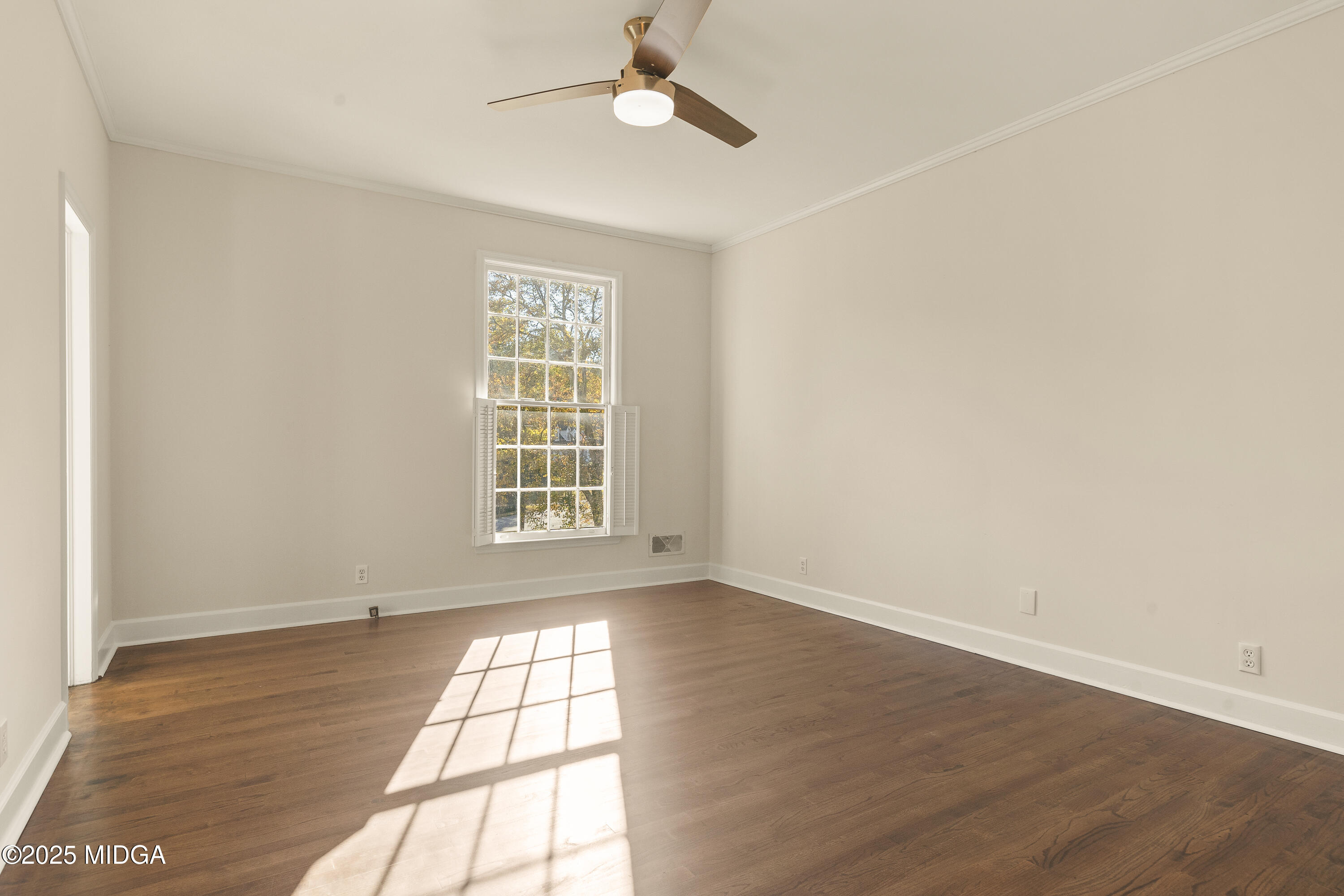 620 Rosa Taylor Drive Macon, GA 31204 - Photo 28 of 45 an empty room with wooden floor ceiling fan and windows