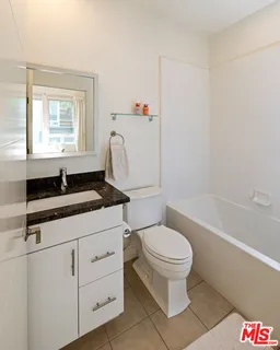 a bathroom with a sink a mirror and a shower