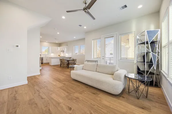 a living room with furniture and a wooden floor
