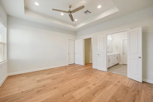 a view of empty room with wooden floor
