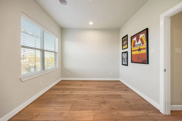 wooden floor in an empty room with a window