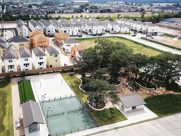 an aerial view of residential houses with outdoor space