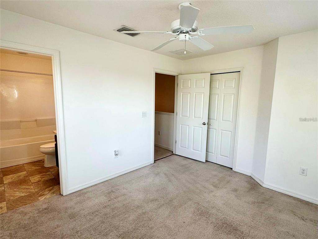 7006 Spotted Deer Place Riverview, FL 33578 - Photo 13 of 21 an empty room with closet and a ceiling fan