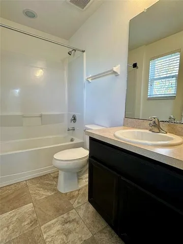a bathroom with a sink toilet a mirror and shower