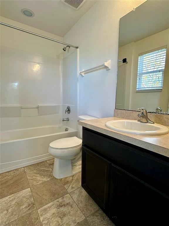 7006 Spotted Deer Place Riverview, FL 33578 - Photo 15 of 21 a bathroom with a sink toilet a mirror and shower
