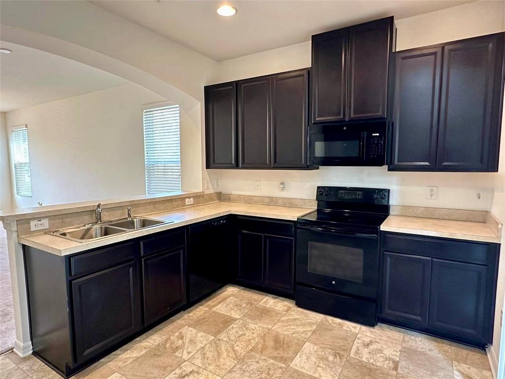 7006 Spotted Deer Place Riverview, FL 33578 - Photo 3 of 21 a kitchen with a sink and a stove