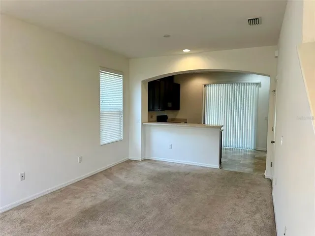 a view of a kitchen with a sink and a television