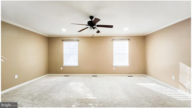 a view of room with a ceiling fan and window