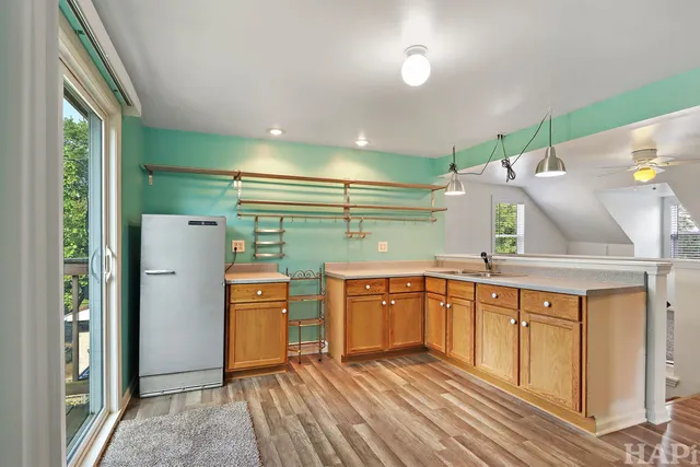 a kitchen with stainless steel appliances granite countertop a refrigerator a sink and dishwasher